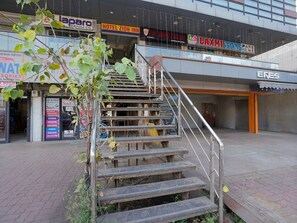 A staircase leading to a building with various signs, including a hotel and a toy store.