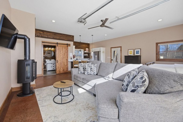 Spacious couch and wood stove for relaxing