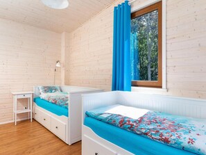 A room with two bunk beds, a small desk, a lamp, and a window with curtains. - Comfortable Holiday Home , Summer Pool (Rewal)