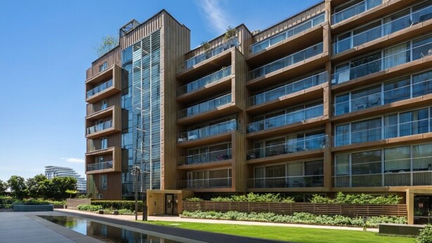 A multi-story building with balconies, large windows, and a pool area. - Refined Luxury 2B2B Home – right next to Battersea Power Station (London)