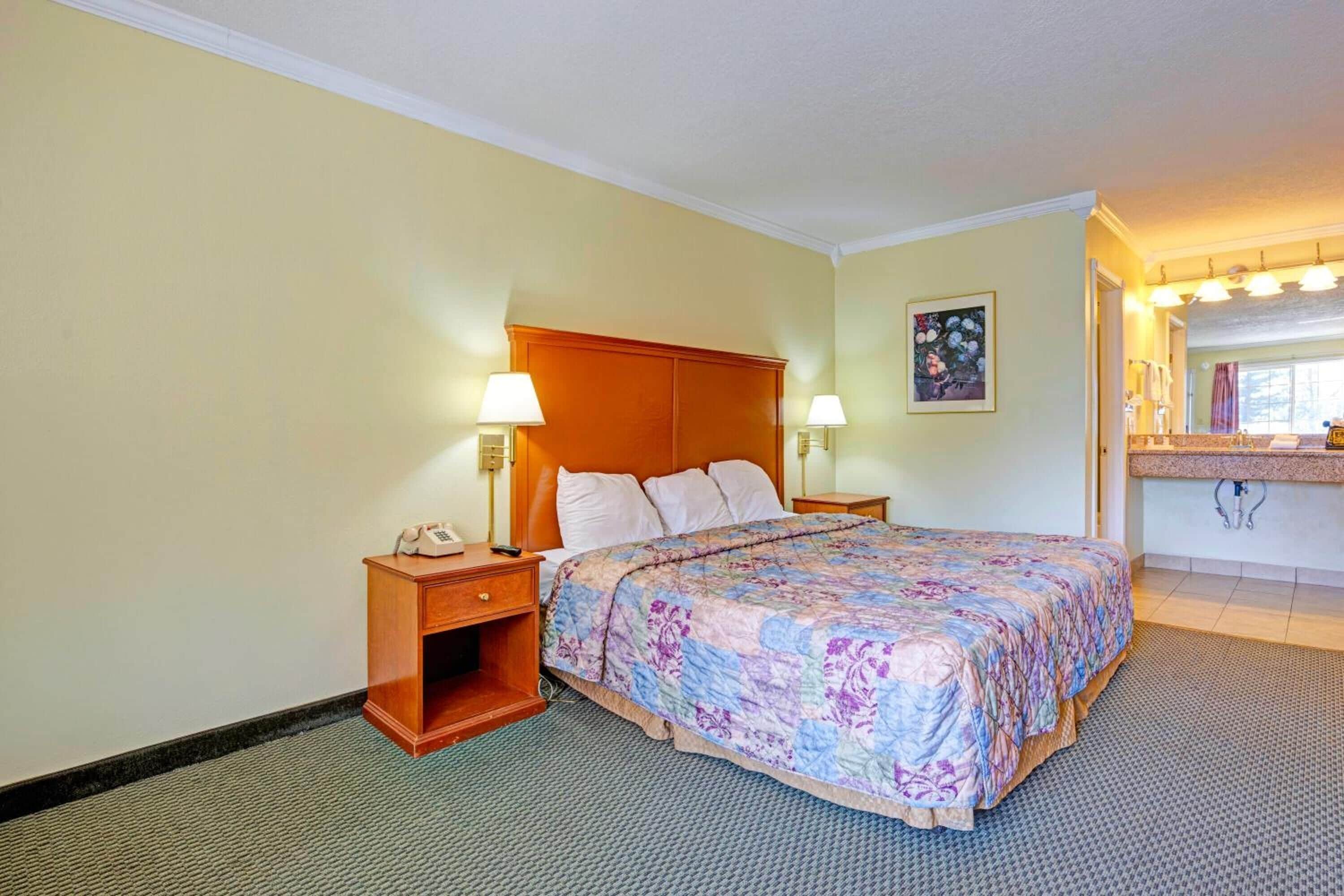 Unwind on a freshly made bed under warm, calming light.