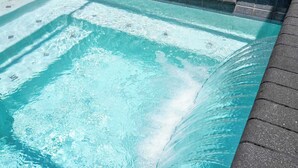 A clear pool with visible water movement, surrounded by a tiled edge. - Premium Location Near Disney with Pool at Le Reve (Kissimmee)