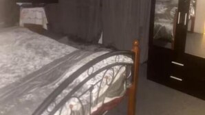 A bedroom with a bed, a ceiling fan, a TV, and a wardrobe. - Room-cozy Private Room With Modern Ameni (Dagenham)
