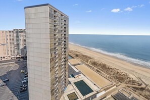 A high-rise hotel with a view of the beach and ocean. - Oceanfront Condo With Pool - Steps To The Beach (Ocean City)
