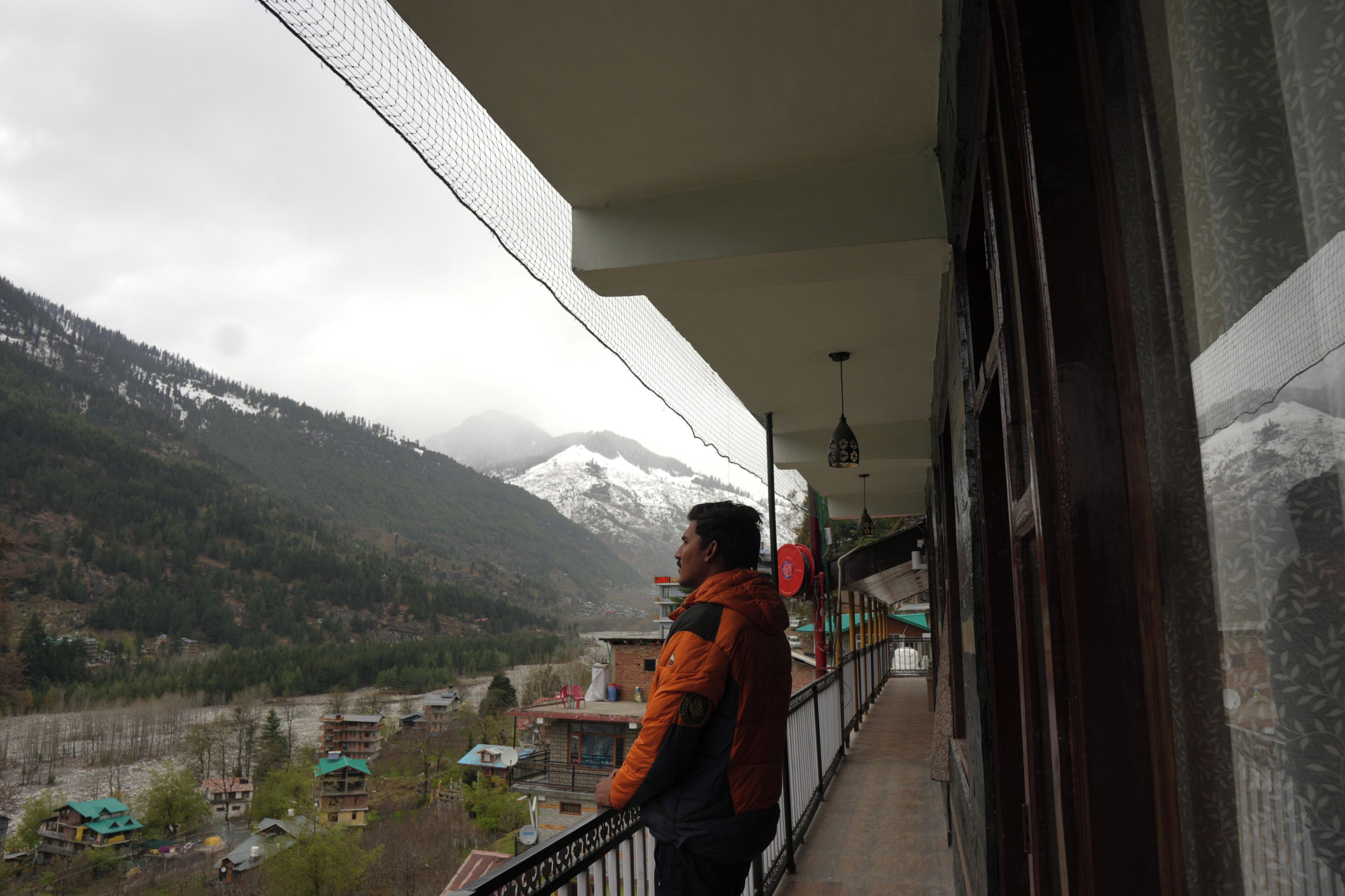 A balcony with a view of a mountainous landscape.
