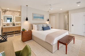 Une chambre moderne avec un grand lit, des tables de chevet, un bureau et une chaise.