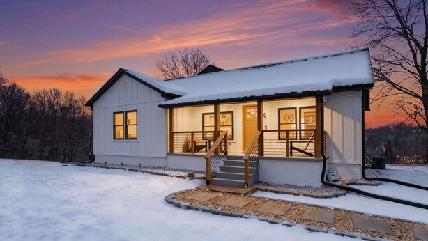 A snow-covered house with a porch, a staircase, and a view of the sunset. - moderno farm house getaway-fire pit game room (Culpeper)