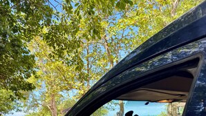 A car's interior with a steering wheel, dashboard, and side mirror. - Fully equipped car to discover the whole island with ease (Les Abymes)