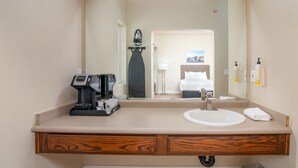 A hotel bathroom with a sink, mirror, coffee maker, and toiletries. - 2 Queen Bed Room- Handicap (Pollock Pines)