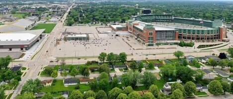 An aerial view of a campus with a large stadium, green spaces, and residential areas.