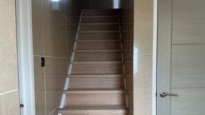 A staircase with wooden steps and beige tiled walls. - Take a Break. Cozy Double Room. Very modern home. Full use of Bathroom,Kitchen (Leyland)