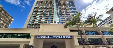A hotel with a prominent sign reading 'Imperial Hawaii Resort' and a visible entrance.