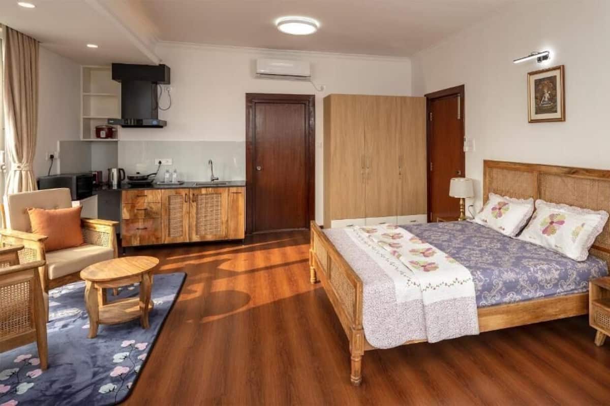A bedroom with a bed, bedside table, and a small wooden nightstand.