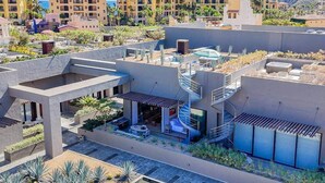 A modern hotel with a rooftop terrace, outdoor seating, and a spiral staircase. - Nauti Baja- Condo at The Marina/Near the Beach! (Cabo San Lucas)