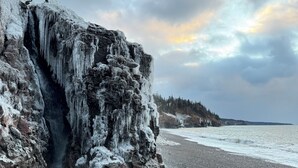 A rocky shoreline with an ice formation and a pebble beach. - Private Oceanfront Log Home nestled right on the world famous Bay of Fundy (Middleton)