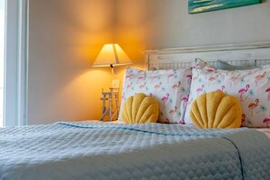A bed with a quilted cover, two yellow pillows, a lamp, and a chair. - West End, Beautiful Ocean Views, Across From Beach, Pool (Panama City Beach)
