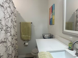 Een haardroger, handdoeken, zeep, toiletpapier