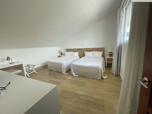A hotel room with two beds, a desk, a chair, and a window with curtains. - Bright 2-bedroom apartment with AC in luxury Cosón beach complex (Las Terrenas)