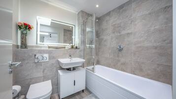 Shower, hair dryer, towels, toilet paper