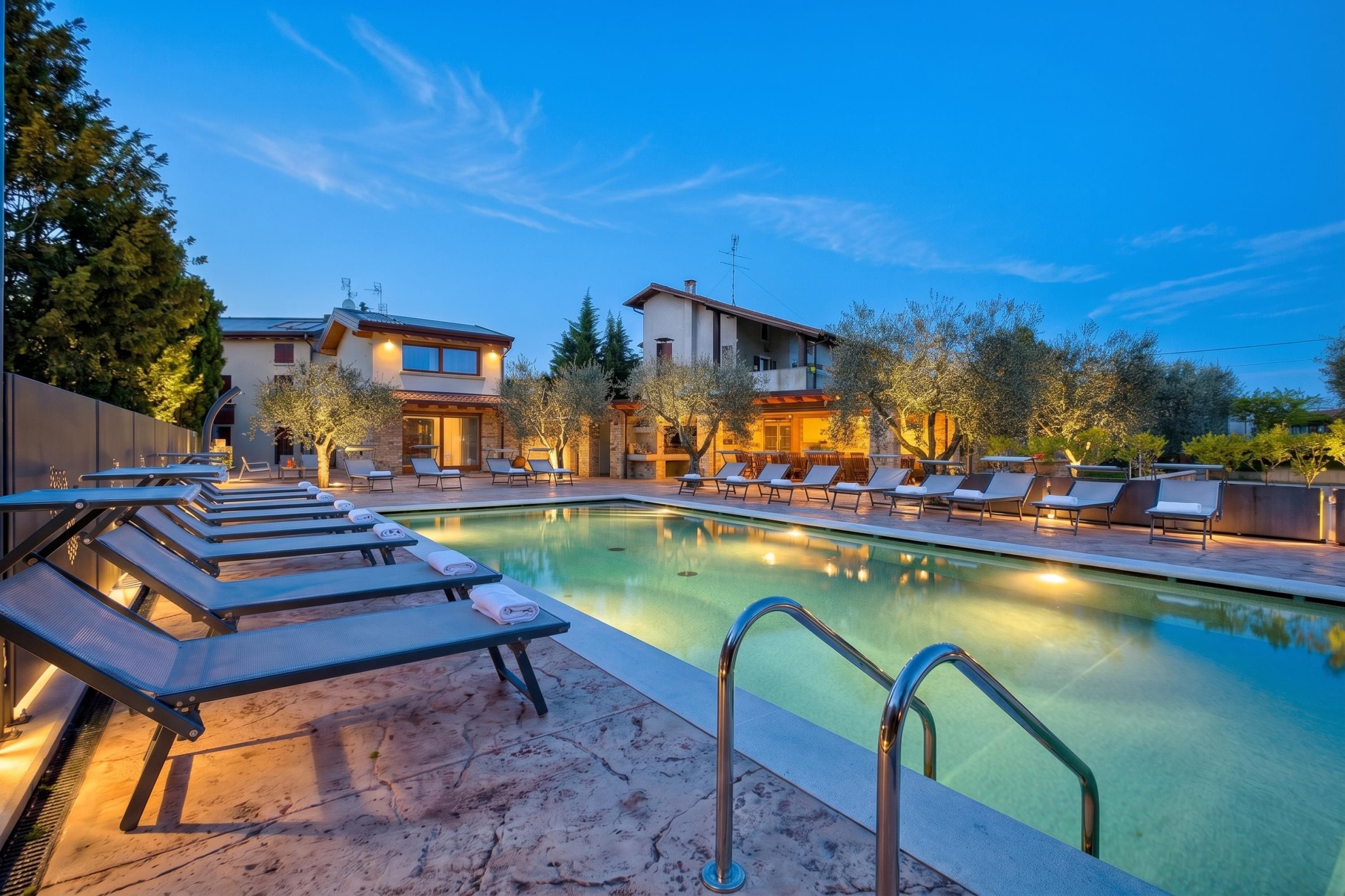 A poolside area with lounge chairs and a swimming pool.