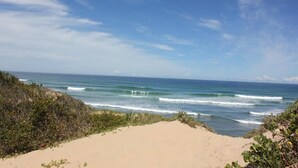 A beach with clear skies and ocean waves.