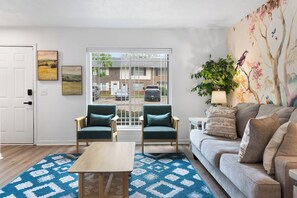 A living room with a sofa, two armchairs, a coffee table, and a patterned rug. - 2BR 1.5BA Gorgeous Condo Near Hospitals - Shopping (Saint Andrews)