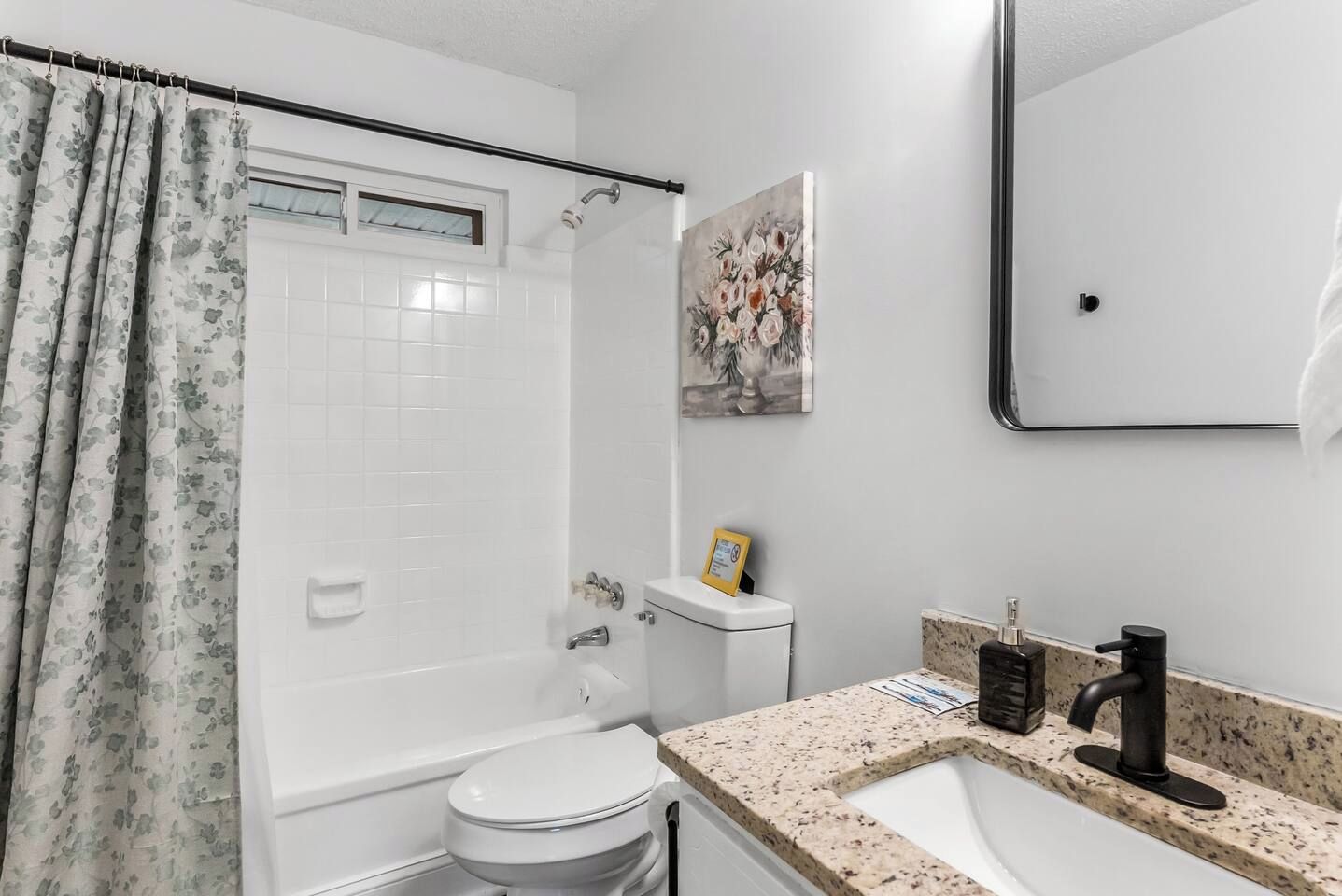 A bathroom with a bathtub, toilet, sink, and shower.