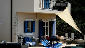 A two-story building with a balcony, outdoor seating, and a pool. - Villa Mediterranea Seaview Primošten (Primosten)