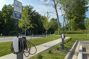 An EV charging station with a sign indicating guest use only for Hilton. - Homewood Suites by Hilton Walker Grand Rapids North (Grand Rapids)