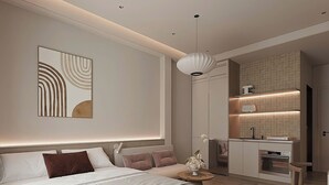 A modern bedroom with a large bed, bedside tables, a nightstand, a decorative wall piece, a hanging light fixture, and a built-in kitchen area with a countertop and oven. - Co Giang Premier Residence (Ho Chi Minh City)