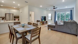 A modern living space with a dining area, kitchen, and seating area. - Beach, Eats, Shops! Sunny Stay in our New 3BR Townhome in Peaceful Palm Coast FL (Palm Coast)