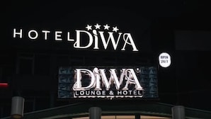 A building with a sign reading 'HOTEL DIWA LOUNGE & HOTEL' and a 'OPEN 24/7' sign. - Diwa Hotel (Tetovo)