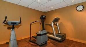 A fitness room with a stationary bike, elliptical, and treadmill. - Edmonton Hotel & Convention Center (Edmonton)