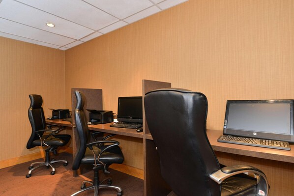 A conference room with three black office chairs, two HP laptops, and a wooden desk. - Edmonton Hotel & Convention Center (Edmonton)