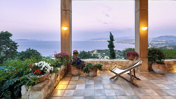 A terrace with a view of the sea, potted plants, and a lounge chair. - Villa Vollard  | 5 Bedrooms with Private Pool Jacuzzi and Panoramic Sea View (Heraklion)