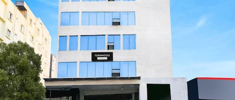 Un edificio de varios pisos con un letrero que dice 'TOWNHOUSE'.