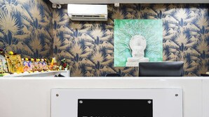 A reception desk with a sign indicating it's a company-serviced townhouse. - Townhouse Hitec City Metro Station (Hyderabad)