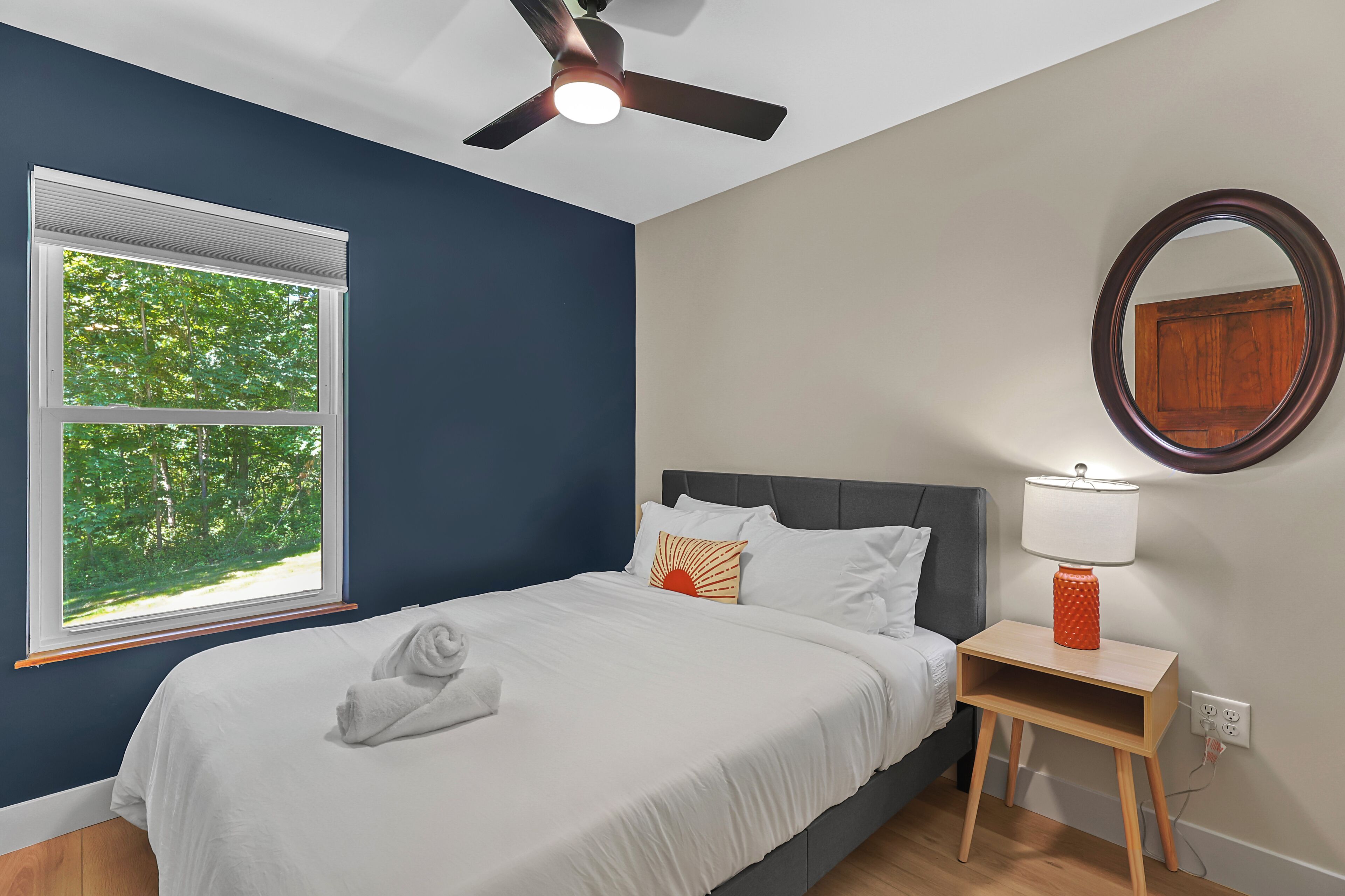 Bedroom 2: First floor/Queen Bed
with comfortable furnishings and wooded views.