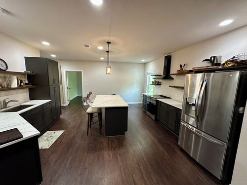 Backyard event space with basement apartment with kitchen, fitness room.