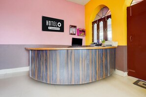 A hotel reception desk with a sign that reads 'HOTEL Company-Serviced.'
