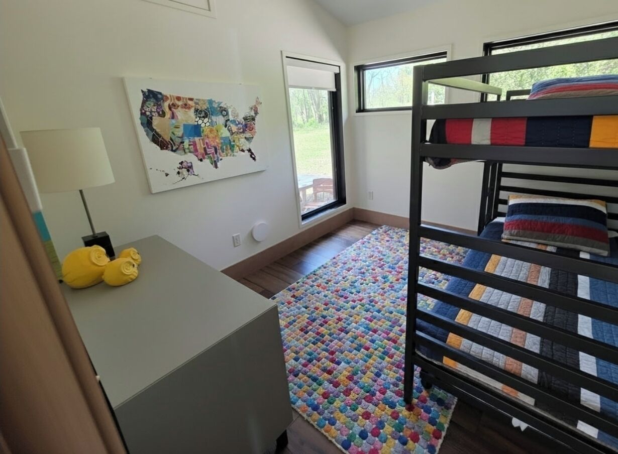 Kids room with twin bunk bed plus pull out trundle.
