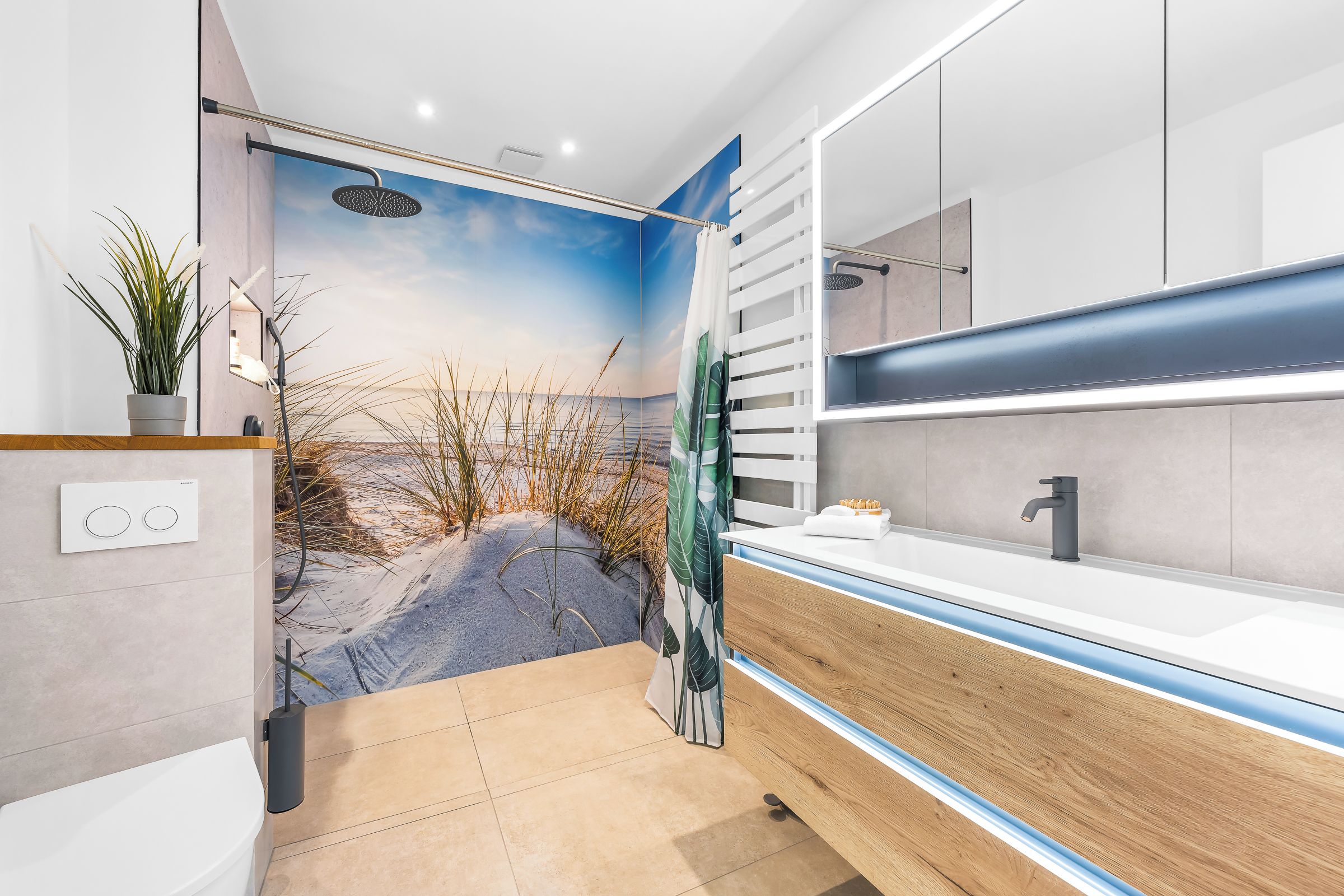 A modern bathroom with a large mirror, a shower with a rain showerhead, and a towel rack.