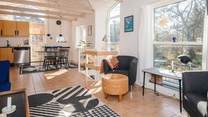 A modern interior with a kitchen, dining area, and seating space. - 4 Person Holiday Home in Grenaa (Grenaa)