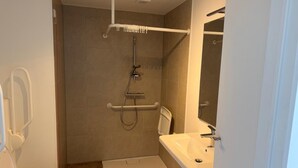 A small, modern bathroom with a shower, toilet, and sink. - City Apartment With Terrace (Hasselt)