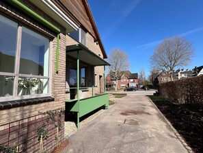 A residential street with houses, a clear sky, and a sidewalk. - Stylish Apartment in Bree Centre (Bree)