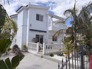 A white two-story building with a balcony, a sign reading 'Villa Mare Vita,' and a gated entrance. - Escape to a stunning luxury villa just a short stroll to the famous Nissi Beach. (Ayia Napa)