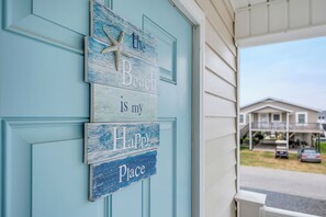 A blue door with a sign that reads 'the Beach is my Happy Place.' - Spacious 4-bedroom Canal Home on Holden Beach (Holden Beach)