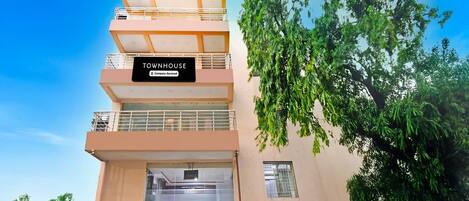A multi-story building with a sign reading 'TOWNHOUSE.'