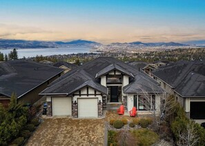 Exterior - Bright open-concept home in Kelowna with lake views, high ceilings, fireplace, and chef’s kitchen. Enjoy a large deck, spa-like ensuite, and private yard.  Minutes away from hikes, beaches, wineries, and downtown. (Kelowna)