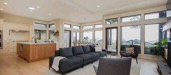 Bright open-concept home in Kelowna with lake views, high ceilings, fireplace, and chef’s kitchen. Enjoy a large deck, spa-like ensuite, and private yard.  Minutes away from hikes, beaches, wineries, and downtown.